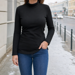 Cranbourne Funnel Neck Thermal Top in black worn with jeans, front view